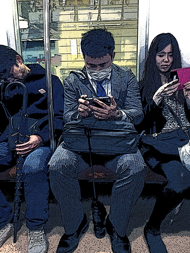 Immagine di passeggeri giapponesi seduti (Per leggerne la descrizione proseguire nel link). Un uomo con maschera sulla bocca al centro, con lo sguardo sullo smartphone e ai lati un uomo addormentato e una donna che guarda il telefono.