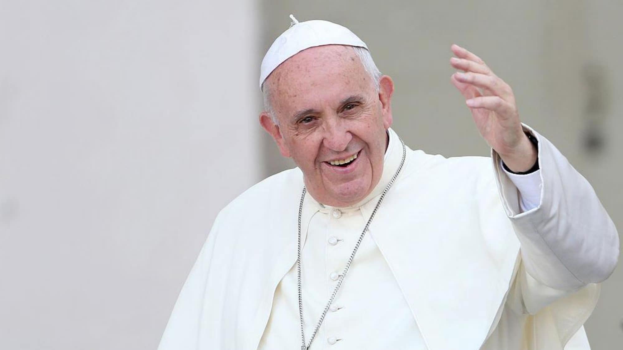 Papa Francesco sorridente mentre saluta